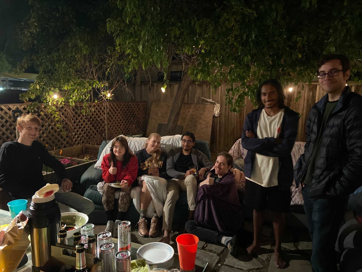 Members relaxing together at an evening backyard hangout.