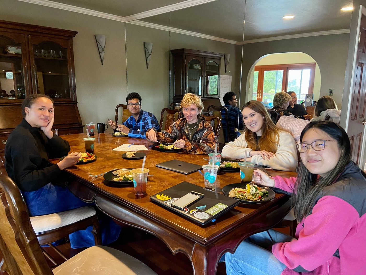 Club members sharing a meal together around a table.